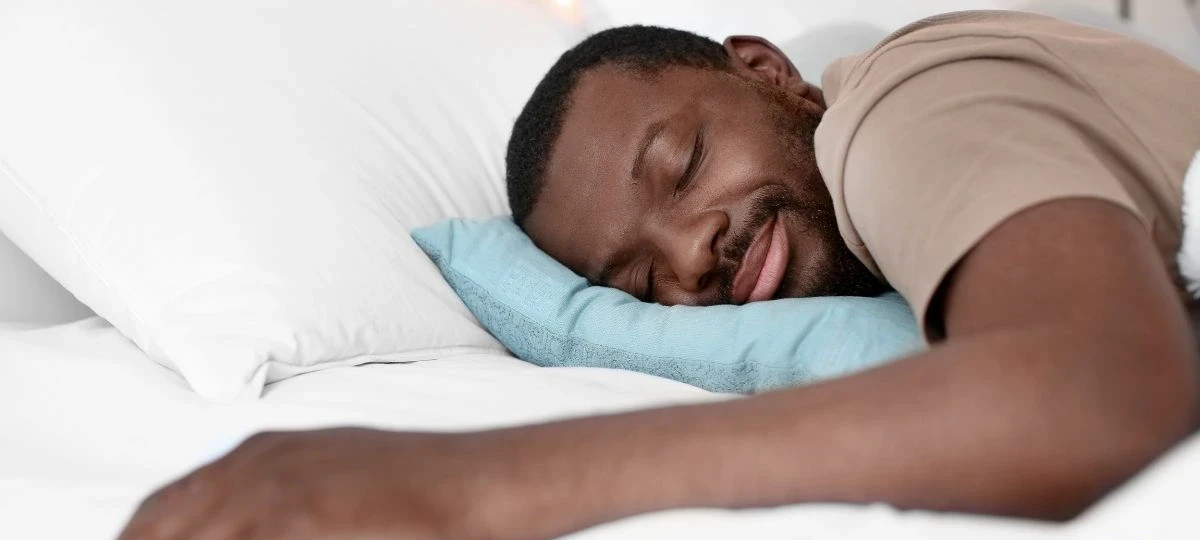 Man sleeping peacefully, representing quality sleep as a daily testosterone-supporting habit