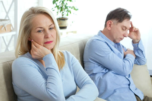 Couple sitting apart, illustrating how performance concerns can affect a relationship